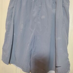 Nike athletic shorts  made of 90% polyester and 10% Spandex Mens LT GL, Grey.
so